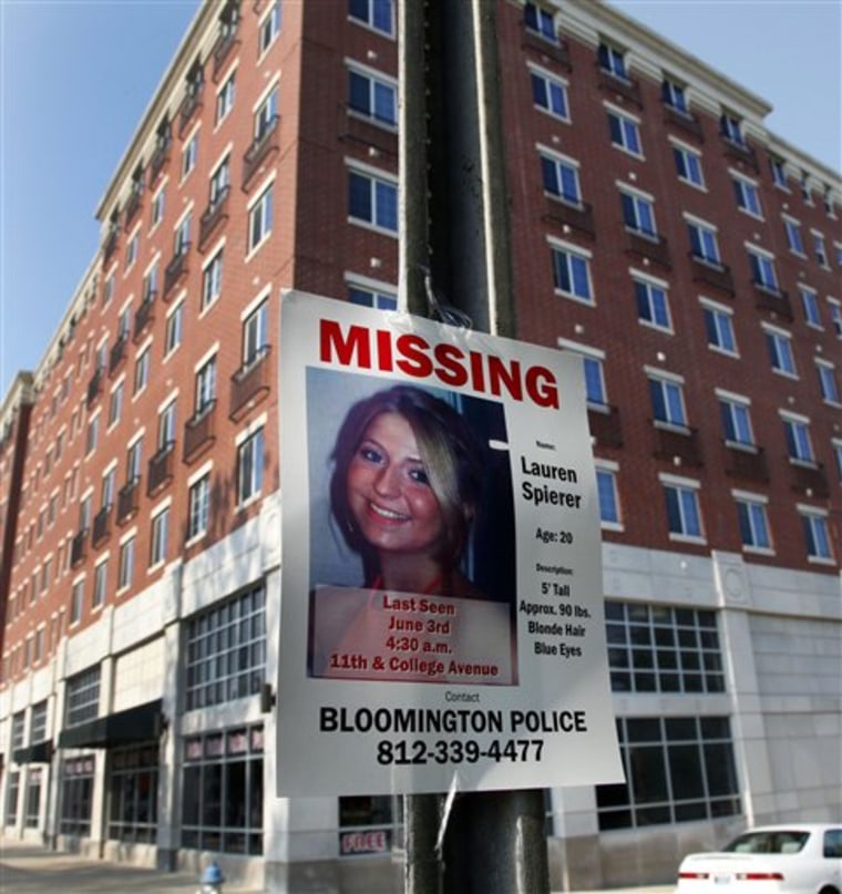 A missing person poster of Lauren Spierer, 20, is posted on a sign post outside her apartment building  in Bloomington, Ind., Tuesday, June 7, 2011.  Spierer disappeared around 4:20 a.m. on Friday.  Police say they suspect foul play in the disappearance of a 20-year-old Indiana University student five days ago, but have little information about what happened to her. (AP Photo/Michael Conroy)
